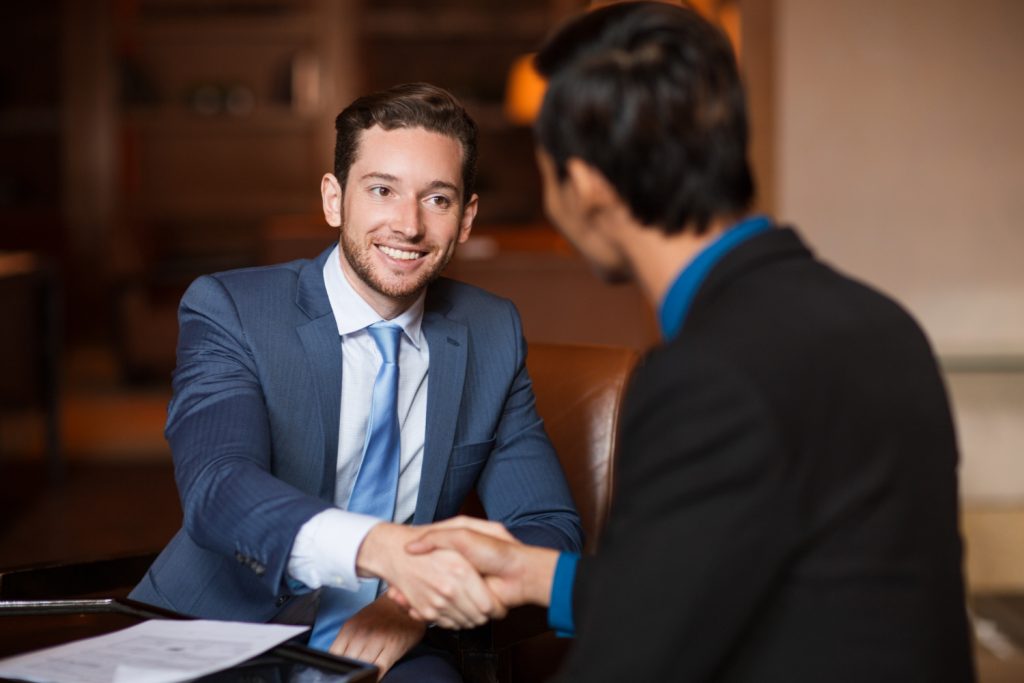 two-happy-partners-shaking-hands-cafe-1024x683